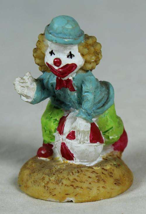 Miniature clown sitting on a balloon