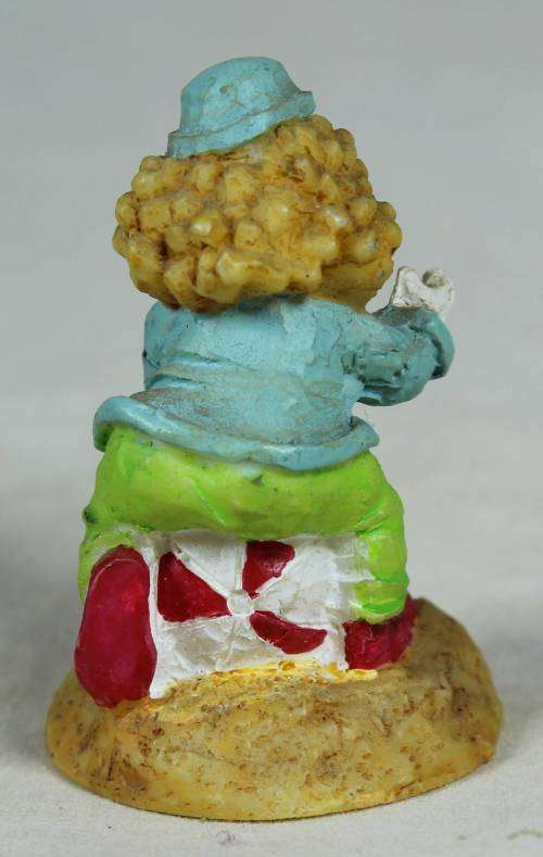 Miniature clown sitting on a balloon