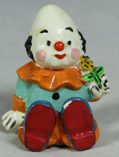 Miniature clown holding a sunflower