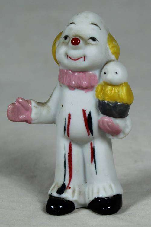 Miniature clown holding a bird