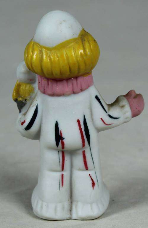 Miniature clown holding a bird