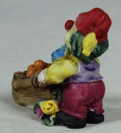 Miniature clown pushing a wheelbarrow