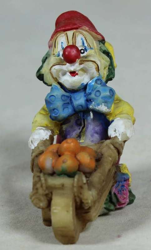 Miniature clown pushing a wheelbarrow