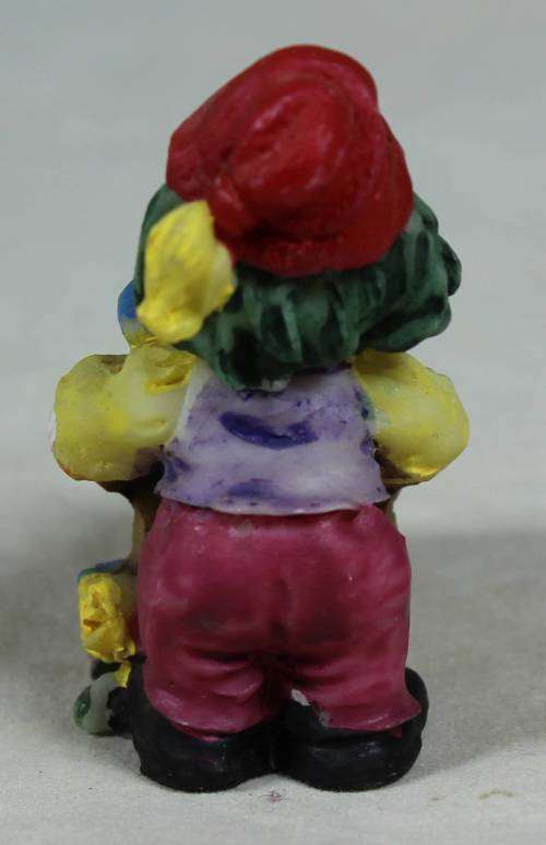 Miniature clown pushing a wheelbarrow