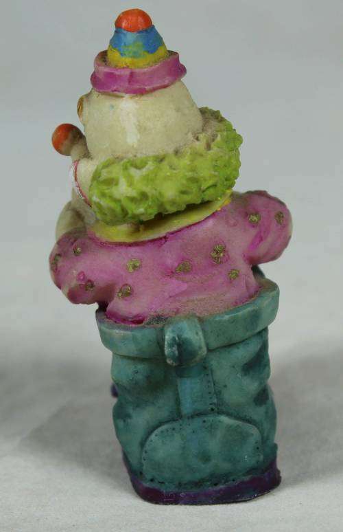 Miniature clown sitting in a shoe