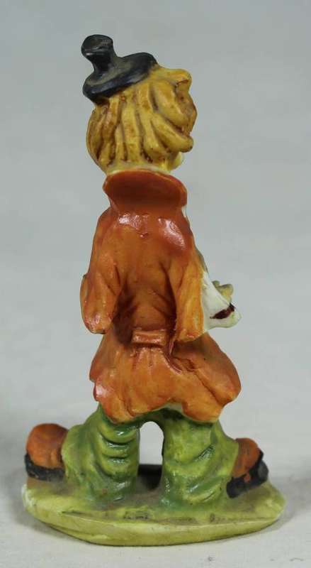 Miniature clown playing a concertina