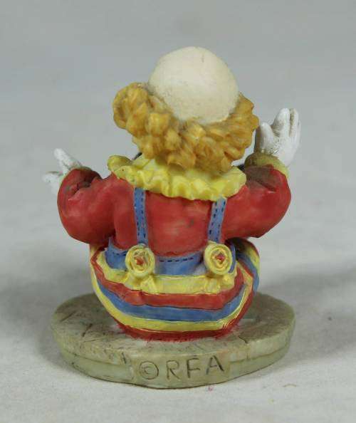 Miniature seated clown with arms stretched open