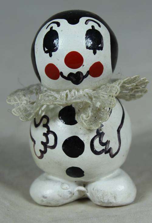 Miniature clown with pouted lips