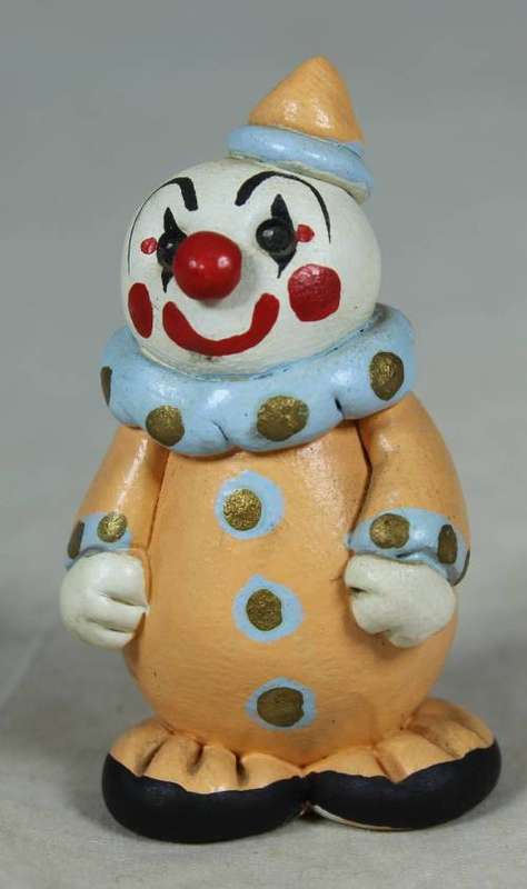 Miniature clown in an orange suit
