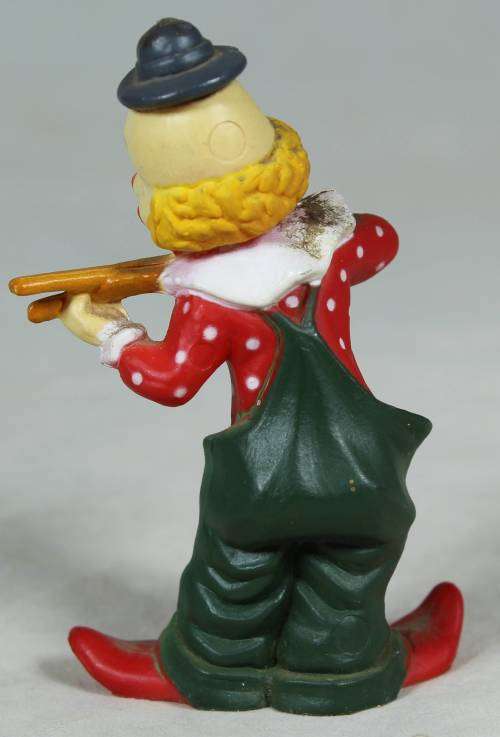 Miniature clown playing with sticks