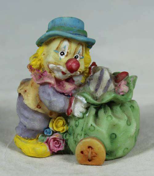 Miniature clown with a gift cart