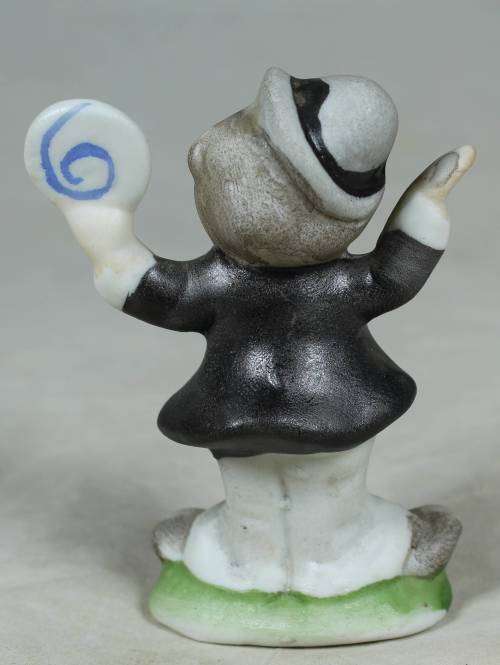 Miniature clown holding a large disk