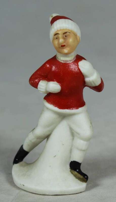 Miniature man in red and a red beanie