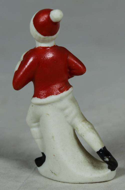 Miniature man in red and a red beanie