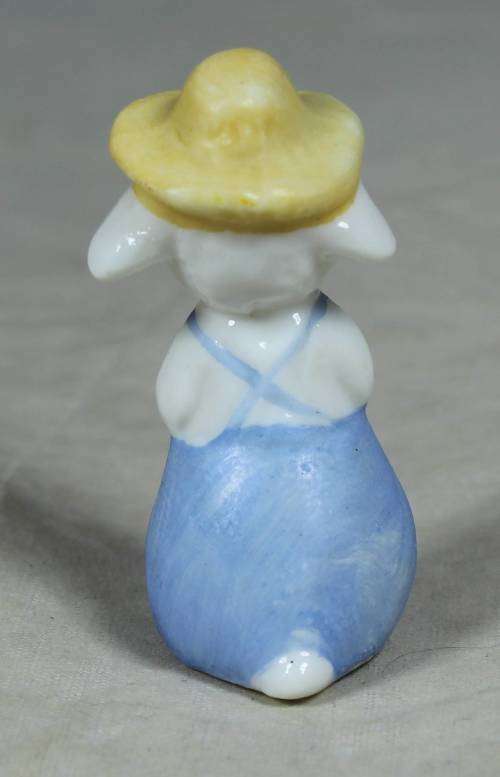 Miniature sheep with a yellow hat