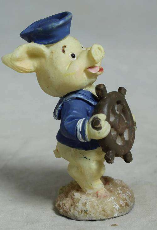 Miniature sailor with a ships wheel