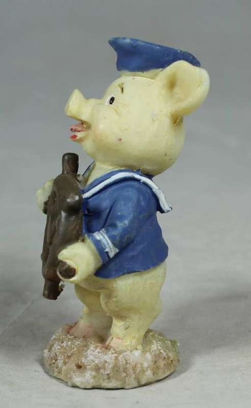 Miniature sailor with a ships wheel