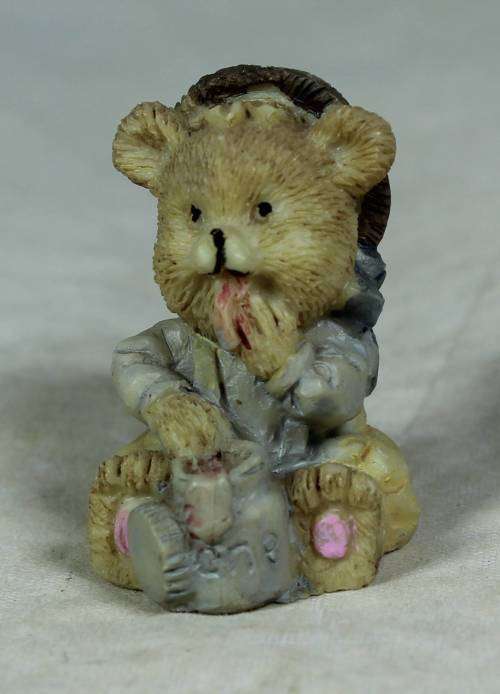 Miniature baby bear eating out of the pot