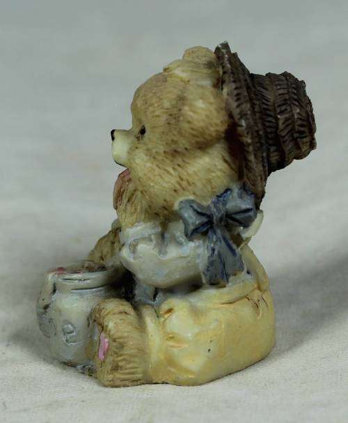 Miniature baby bear eating out of the pot