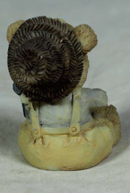 Miniature baby bear eating out of the pot