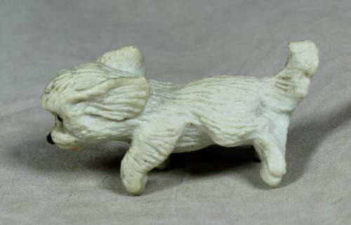 Miniature plastic white dog running