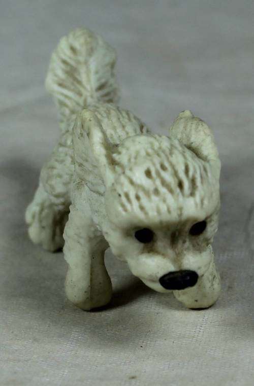 Miniature plastic white dog running