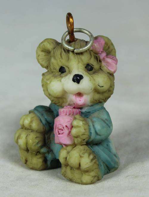 Miniature baby bear drinking out of a mug