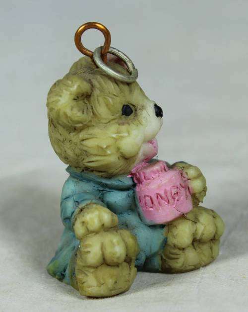 Miniature baby bear drinking out of a mug