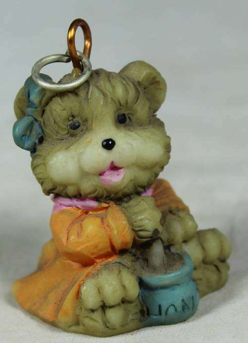 Miniature baby bear stirring a pot