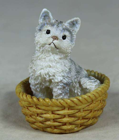 Miniature kitten in a basket