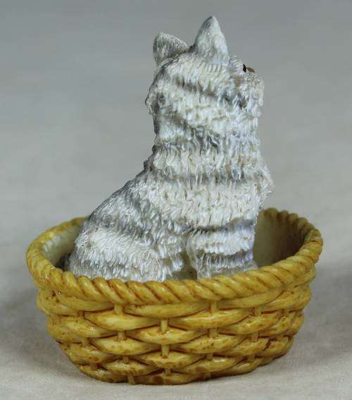 Miniature kitten in a basket