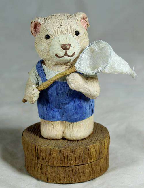 Boy bear with a trinket box underneath holding a net