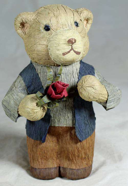 Father bear holding a flower