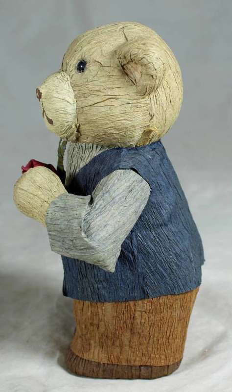 Father bear holding a flower