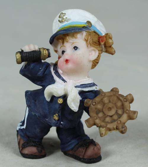 Kid sailor in blue holding a telescope and ships wheel