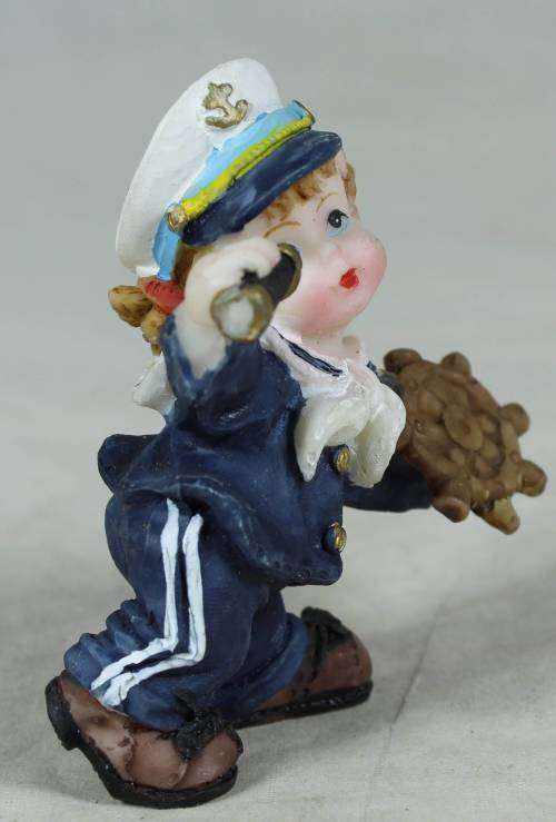 Kid sailor in blue holding a telescope and ships wheel