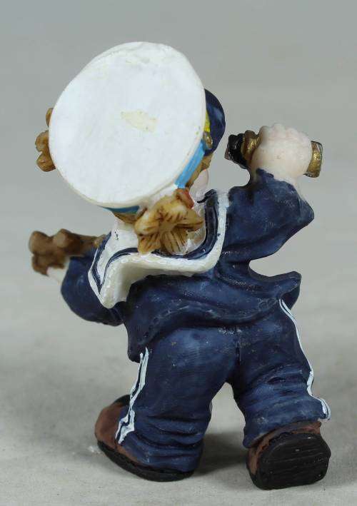 Kid sailor in blue holding a telescope and ships wheel