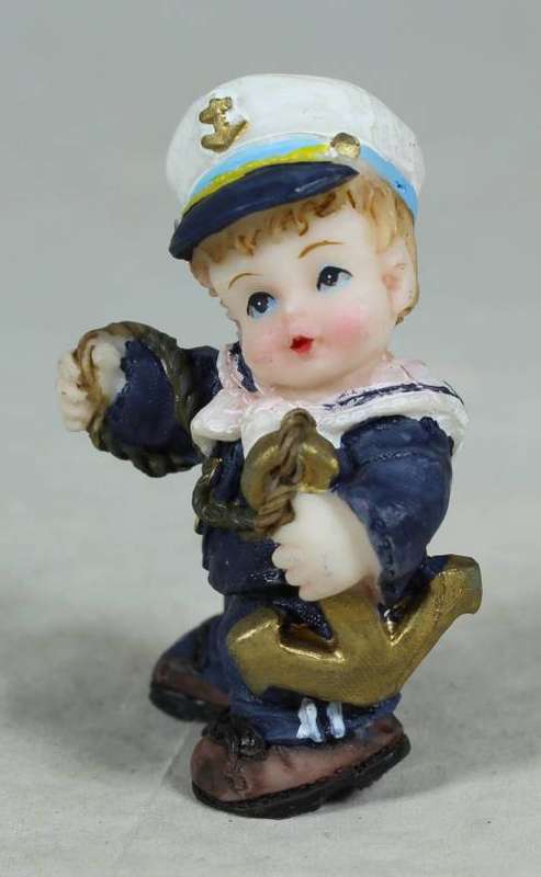 Kid sailor in blue holding an anchor