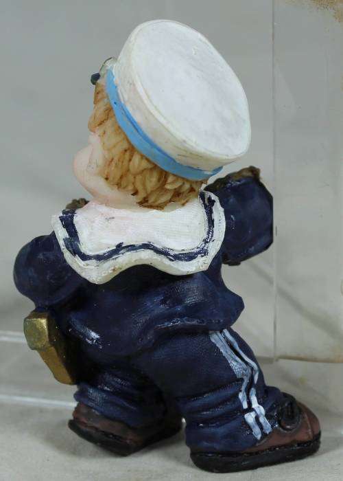 Kid sailor in blue holding an anchor