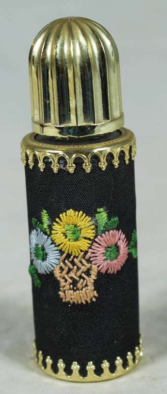 Vintage perfume bottle with needlework body
