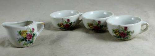 3 Small porcelain cups with a milk jug