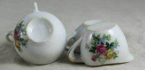 3 Small porcelain cups with a milk jug