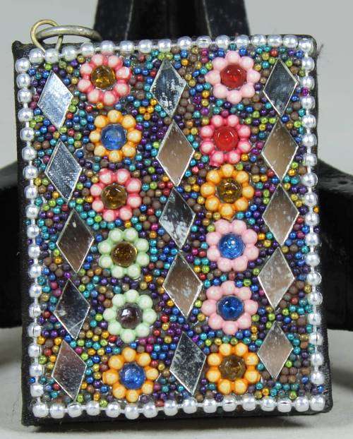 Miniature note book with embezzled covering