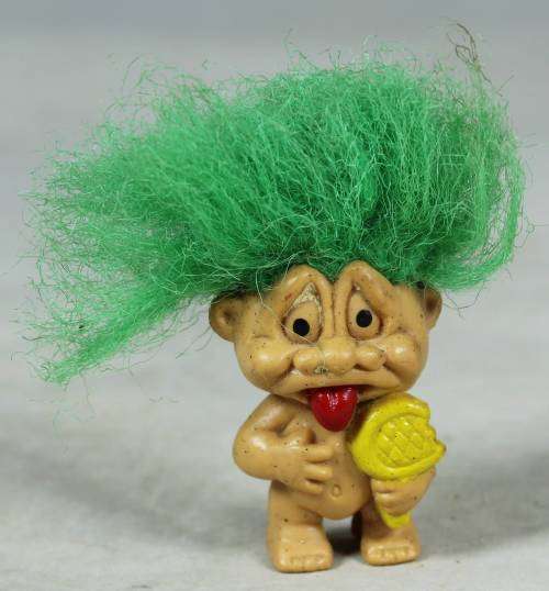 Miniature troll eating a lolly