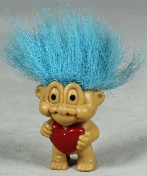 Miniature troll holding a heart