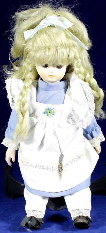 Porcelain doll - girl with pigtails in blue dress