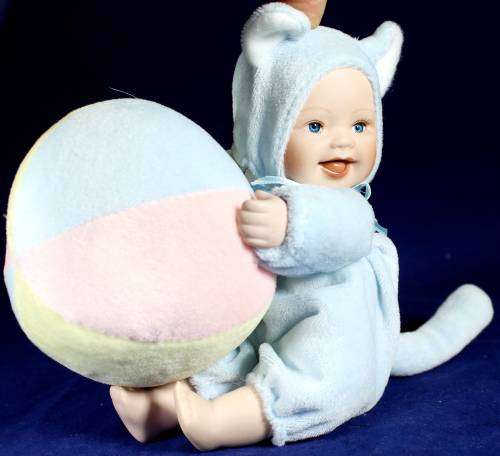 Porcelain doll - baby playing with ball - with music box