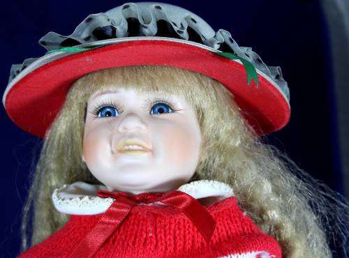 Porcelain doll schoolgirl on stand