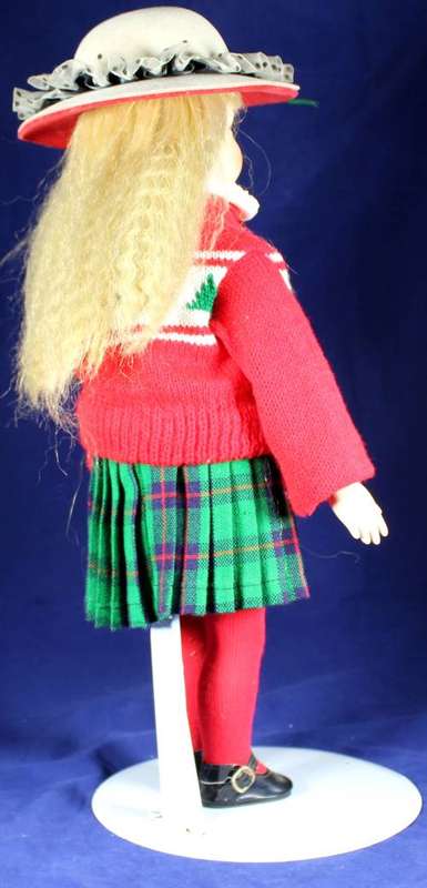 Porcelain doll schoolgirl on stand