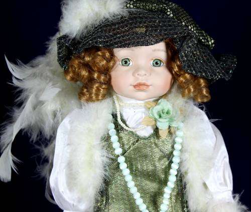 Porcelain doll  Alice in grown up clothes on stand